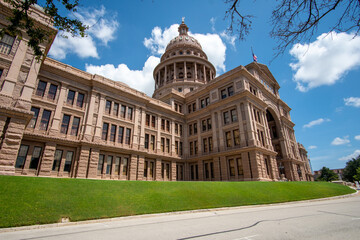Side view of the Austin Capitol Building With Mostly Clear skies during the summer days