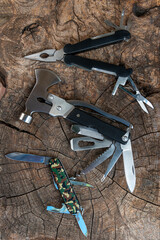 camping and survival multi purpose tools on rustic wooden table ,camping and survival tools for...