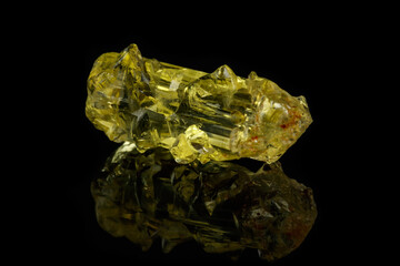 Macro mineral beryl heliodor stone on black background