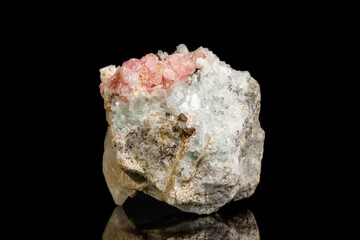 Macro of the mineral stone Rhodochrosite with fluorite on a black background