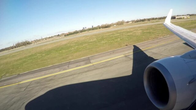 Airplane wing and shadow view after takeoff at Copenhagen airport, Denmark