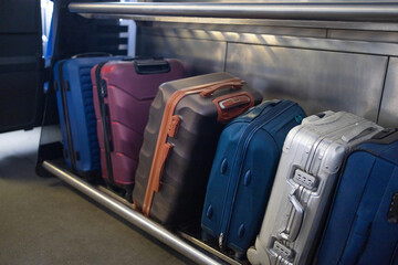 Many different kinds of suitcases and hand luggage bags in the luggage compartment of the train....