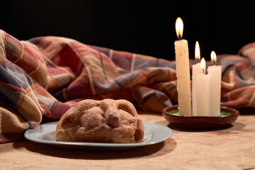 Traditional Mexican bread of the dead. Candle lighting. Enjoyed on the day of the dead. Mexican tradition concept.