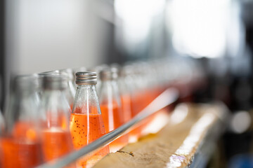 Product of Basil seed with fruit on the conveyor belt in the beverage factory. Bottling line for...
