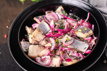 herring pieces with onions pickled salted fish seafood fresh portion ready to eat meal snack on the table copy space food background rustic. top view keto or paleo diet vegetarian food pescetarian 
