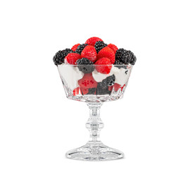 Fresh raspberries and blackberries in a crystal dessert dish topped with whipped cream.
This image has a shadow under the dish