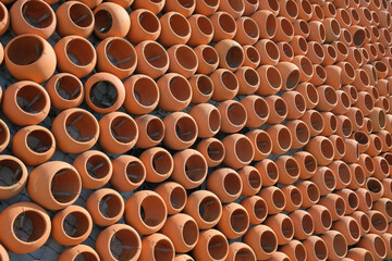 The wall made with rows of ceramic clay pots