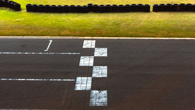 finish line, black and white lane with no cars on the track.