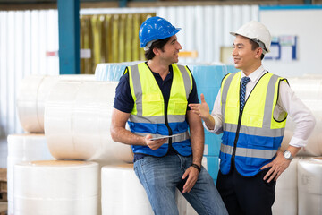 factory workers or engineers talking about work project in warehouse storage