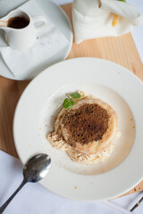 Tiramisu is a coffee-flavoured Italian dessert. It is made of ladyfingers dipped in coffee, layered with a whipped mixture of eggs, sugar, and mascarpone cheese, flavoured with cocoa. 