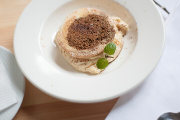 Tiramisu is a coffee-flavoured Italian dessert. It is made of ladyfingers dipped in coffee, layered with a whipped mixture of eggs, sugar, and mascarpone cheese, flavoured with cocoa. 