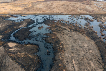 Oil spill near the highway. Environmental pollution