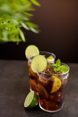 Cuba Libre cocktail. Alcoholic drink with cola, rum, lime and mint. Cuba Libre or long island iced tea cocktail.