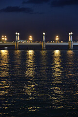 Obraz premium San Sebastian, Spain - 29 Aug 2021: Lights from the Kursal Bridge reflecting on the waters of the Urumea River