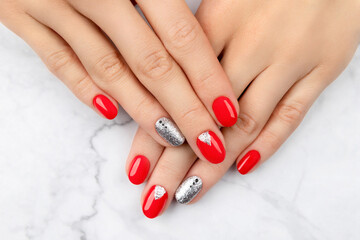 Woman's hands with fashionable red manicure. Christmas new year nail design.