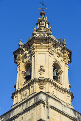 Fototapeta na wymiar Hondarribia, Spain - 29 Aug 2021: The tower of the Church of Santa Maria in old town Hondarribia, Basque Country, Spain