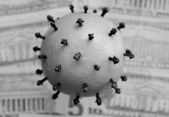 Covid-19 virus on banknotes and coins of different currencies symbolizing the impact of the pandemic on the economy