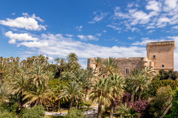 Fototapeta na wymiar Altamira castle and palm grove of elche declared world heritage. Located in the Valencian Community, Alicante, Elche, Spain