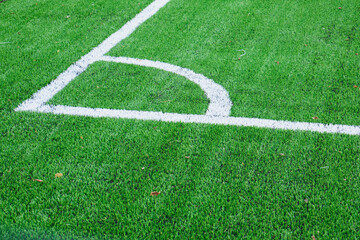 Fototapeta premium new soccer field, green turf and white dividing lines on the soccer field, corner and edge of the field, field markings