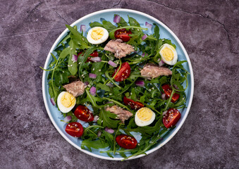 fresh salad with canned mackerel, arugula and tomatoes