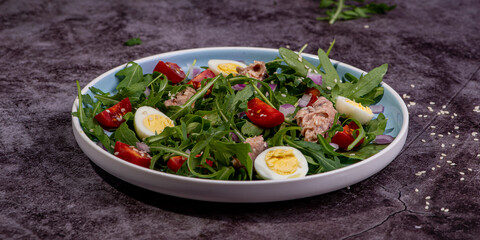 fresh salad with canned mackerel, arugula and tomatoes