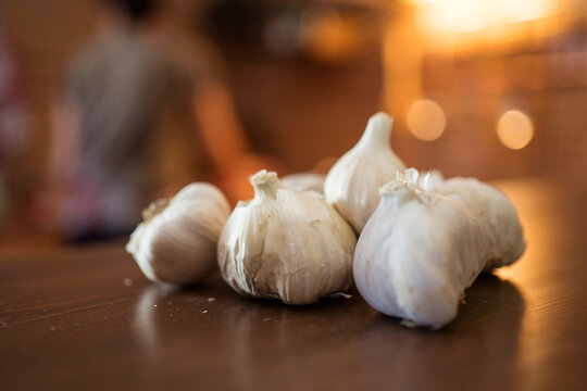 Raw garlic heads on wooden table