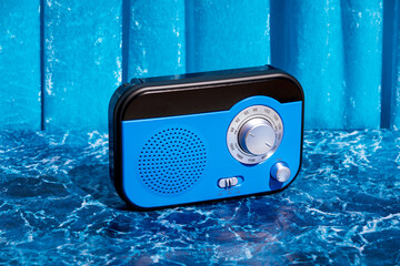 Blue radio receiver on table in studio