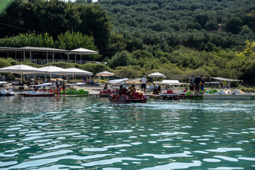 unexpected postures of people resting on a mountain lake 