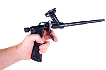 A gun for polyurethane foam in a man's hand on a white background