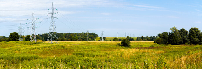 High voltage electric pylon and electrical wire at field