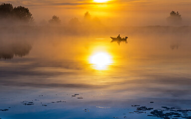 Fishing boat at golden misty morning, calm weather and pacification mood