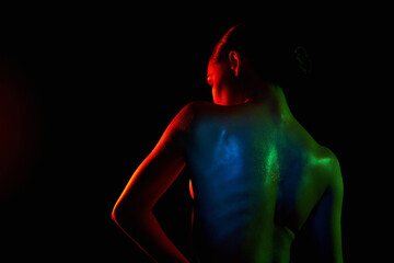 Female back silhouette, beautiful woman in color lights. Art design, colorful girl with radiance body