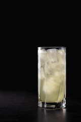 reshly squeezed lemonade with mint in a tall glass with ice.