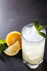 reshly squeezed lemonade with mint in a tall glass with ice.