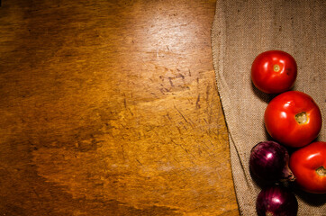Fresh tomatoes and onions on rustic background
