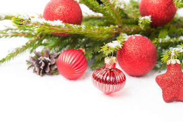 Christmas tree toys on a Christmas tree branch isolated on a white background, close-up
