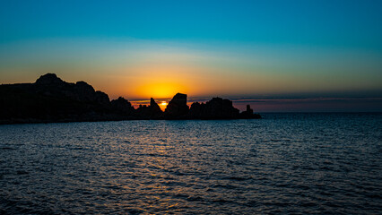 Naklejka na ściany i meble sunset view to the sea with coastline. Sardinia, Italy.