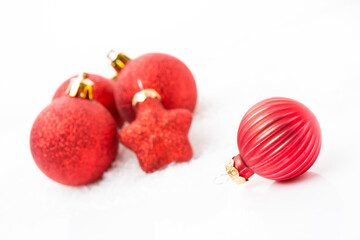 Christmas tree toys, red Christmas balls on a white background, close-up