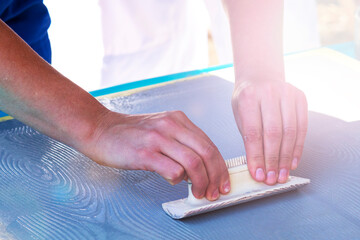 painter, decorator, plasterer. Hand with trowel. Decorative plaster applied on the surface by a...
