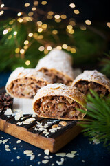 Homemade Christmas dessert, apple strudel, cake on the festive table with garlands