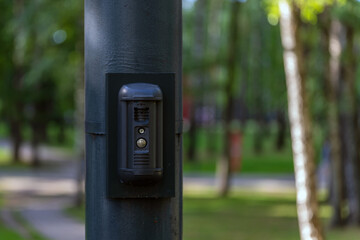 Security call button with camera and sensors on a metal pole