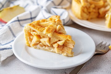 Apple cake with fresh apple slices and cups of tea