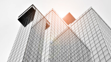 Modern architectural details. Modern glass facade with a geometric pattern. Contemporary corporate business architecture. Red sun on horizon. Black and white toned image.