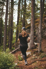 Motivation to lose weight. Running in the forest along the trail. Fitness alone with nature.