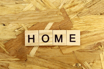 word Home made of wooden blocks on osb background