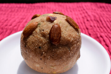 Churma ladoo or atta laddoo made from wheat flour, jaggery and ghee. Big size sweet for religious offering to lord ganesha for ganesh chaturthi festival and all festival celebrations