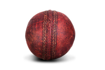 Old red cricket ball isolated on white