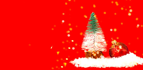 Fototapeta na wymiar Christmas tree toy of fir tree and Red Christmas bauble on snow texture. Christmas greeting card with place for your text.