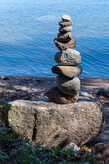 A manmade pile of rocks on the shore against blue sea