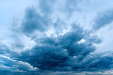 Fototapeta premium Dramatic stormy cumulus clouds at the sky in spring dusk